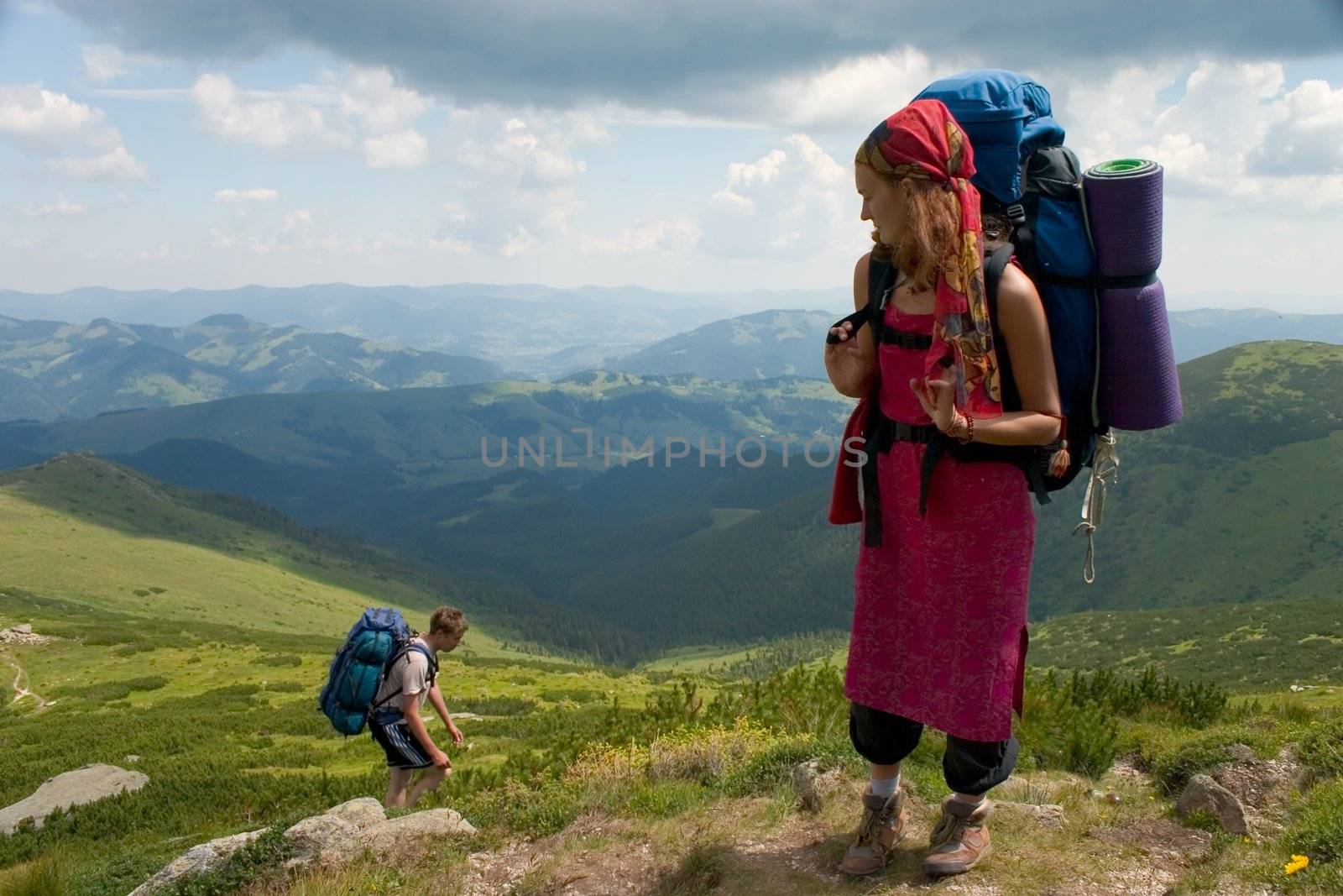 Couple of backpackers hiking in a mountain