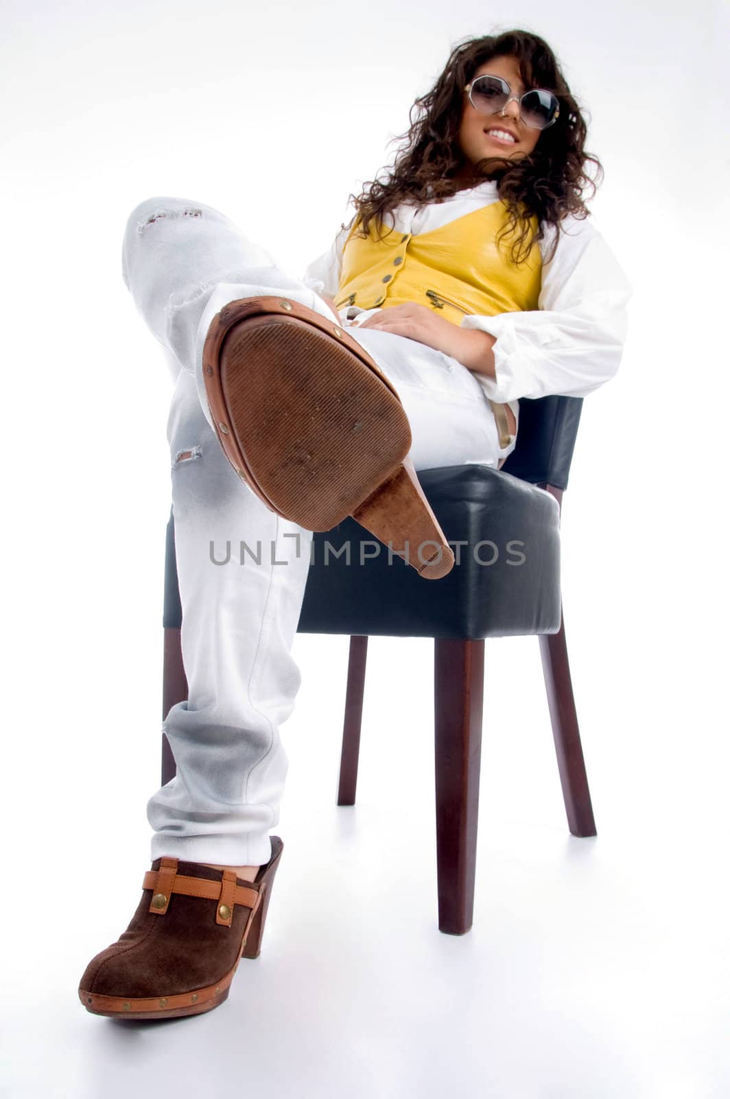 smiling woman sitting on chair on an isolated background