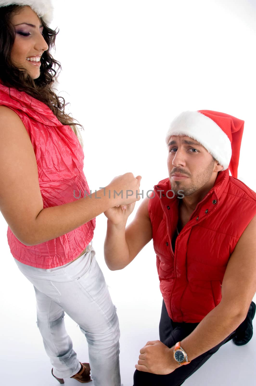 man proposing to the woman with christmas hat by imagerymajestic