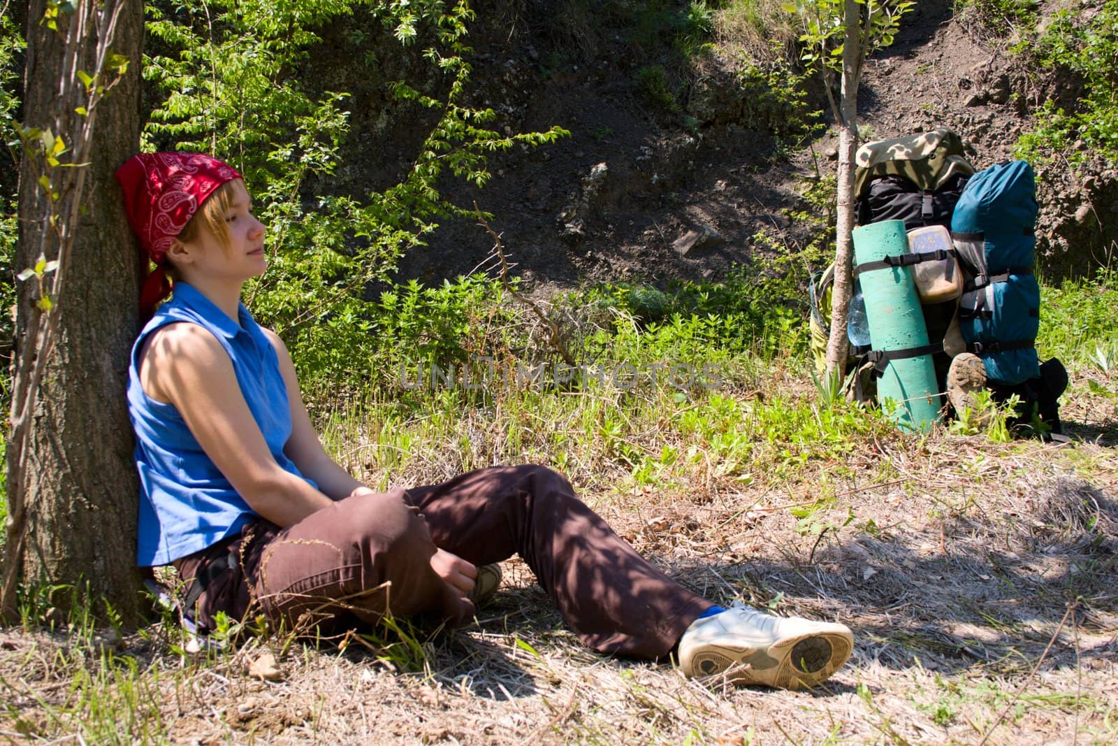 hiker girl takes a rest under the tree