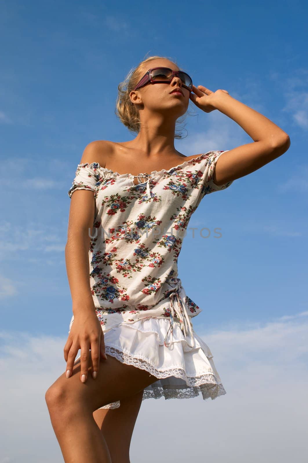 girl in sunglasses on sky background