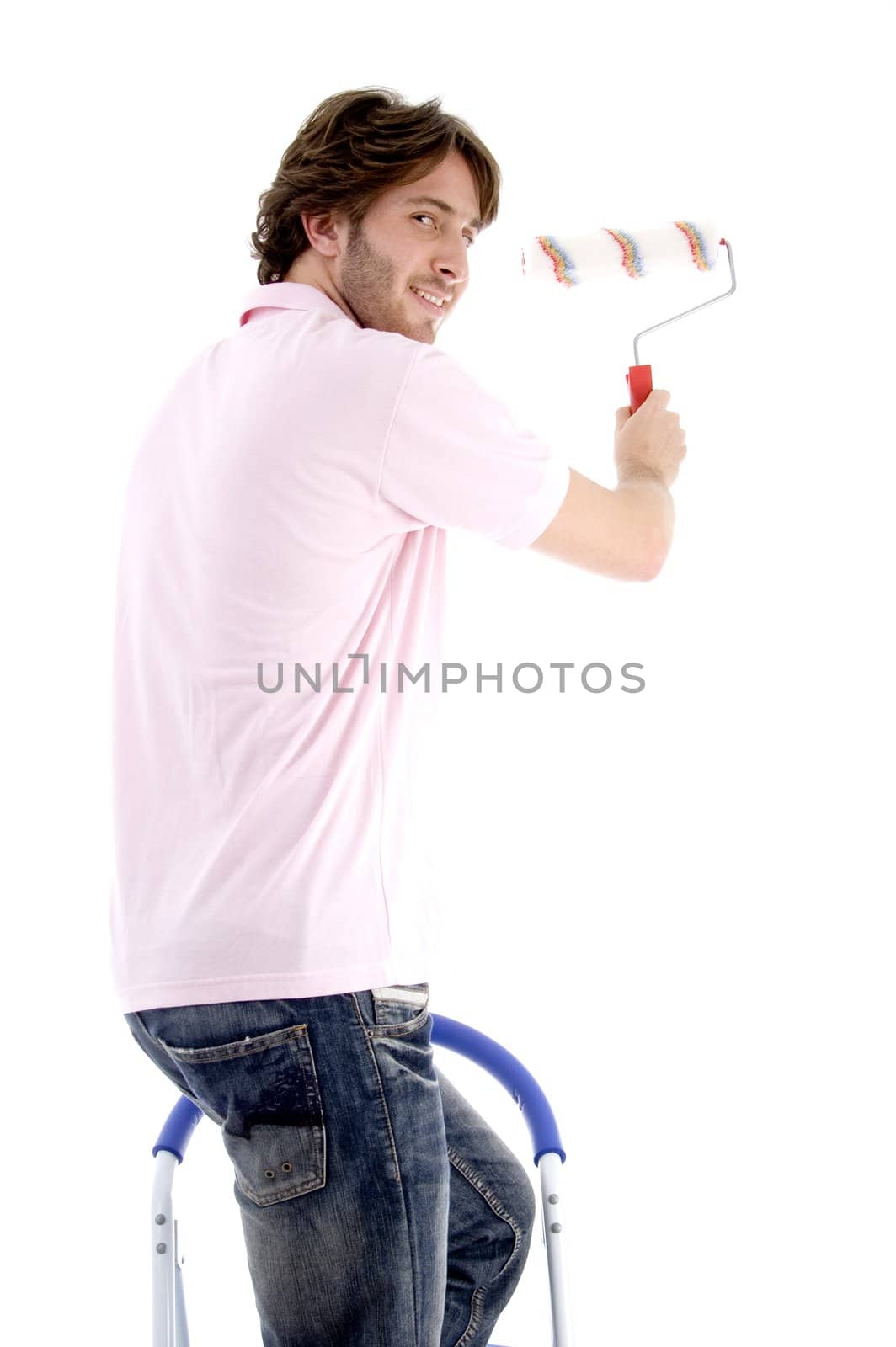 man standing on chair and holding paint roller on an isolated white background