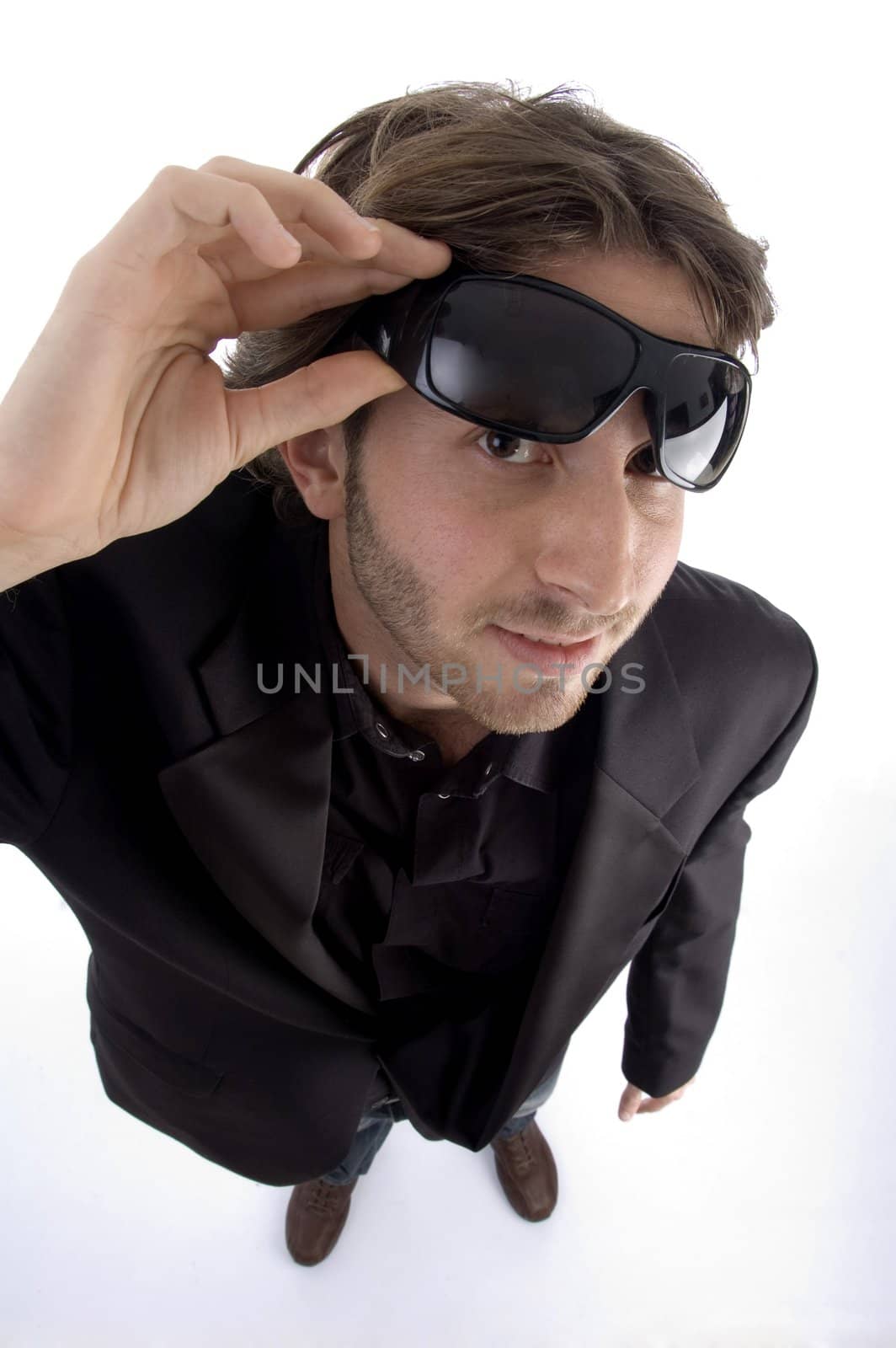 standing man holding sunglasses on an isolated background