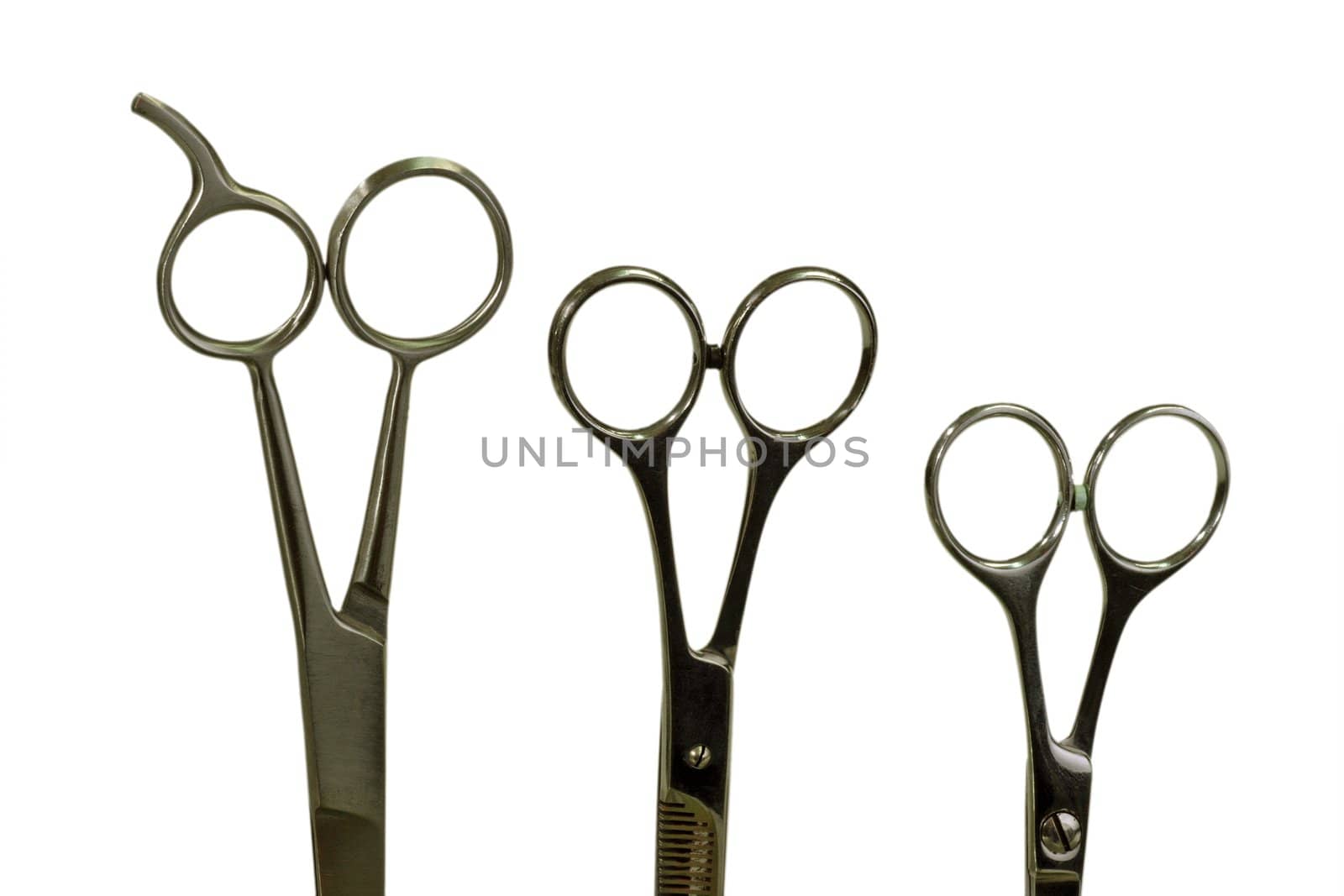 Haircutting scissors on bright background