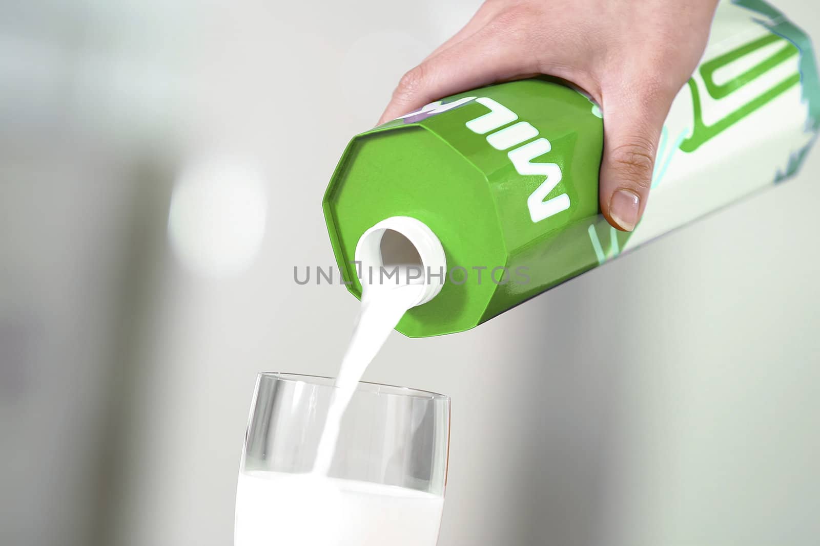 Pouring milk from pack in the glass