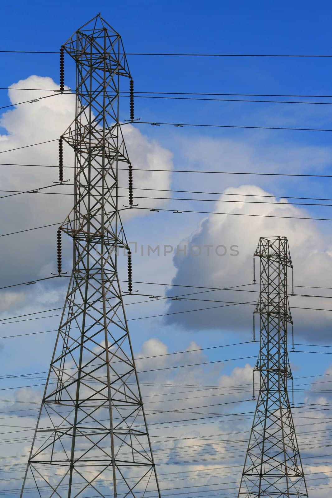 Top of the electricity pylons over cloudscape.
