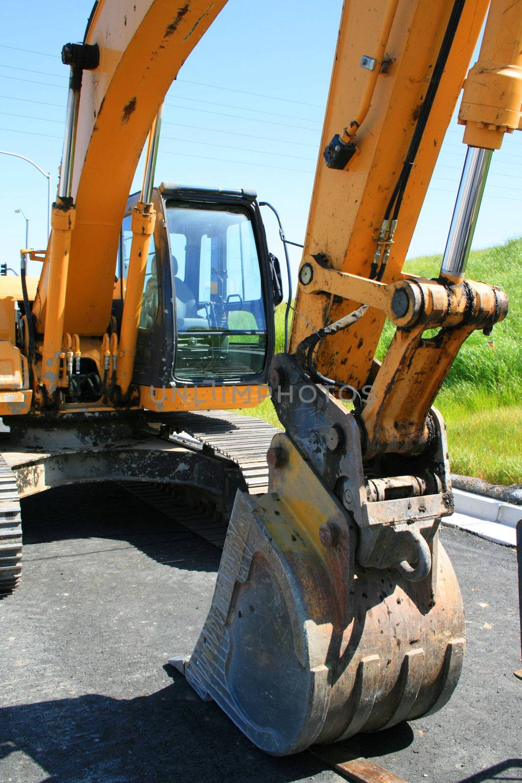 Yellow excavator close up on a construction sight.
