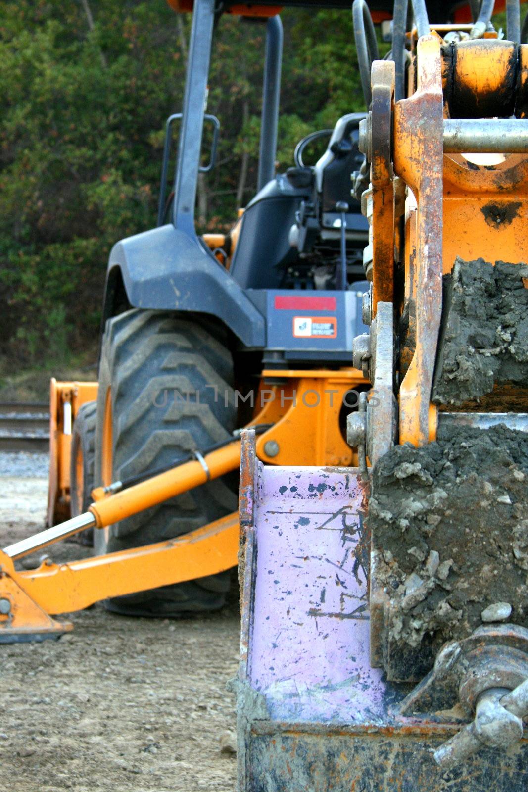 Yellow excavator close up on a construction sight.
