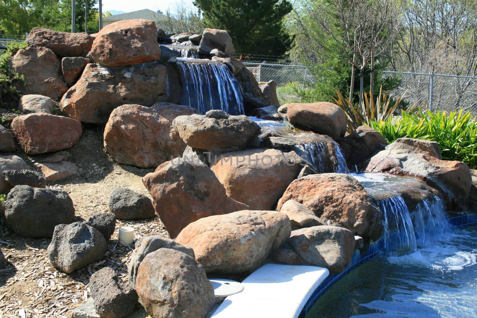 Close up of a waterfall in a garden.
