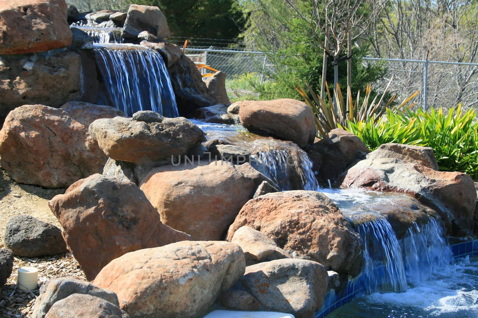 Close up of a waterfall in a garden.
