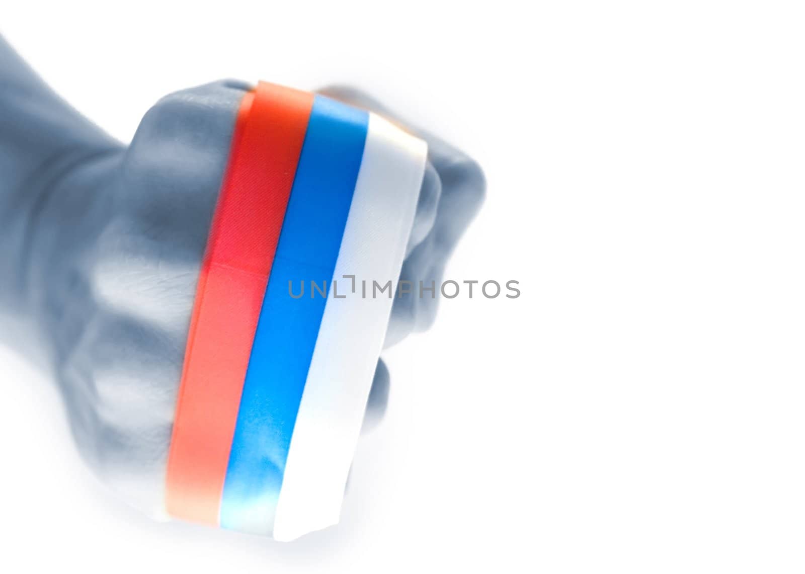 A hand clenched in a fist with russian ribbon