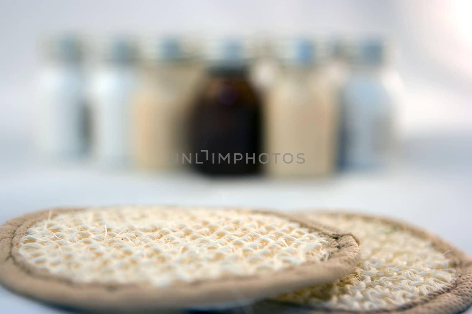 Two sponges and bottles on the background