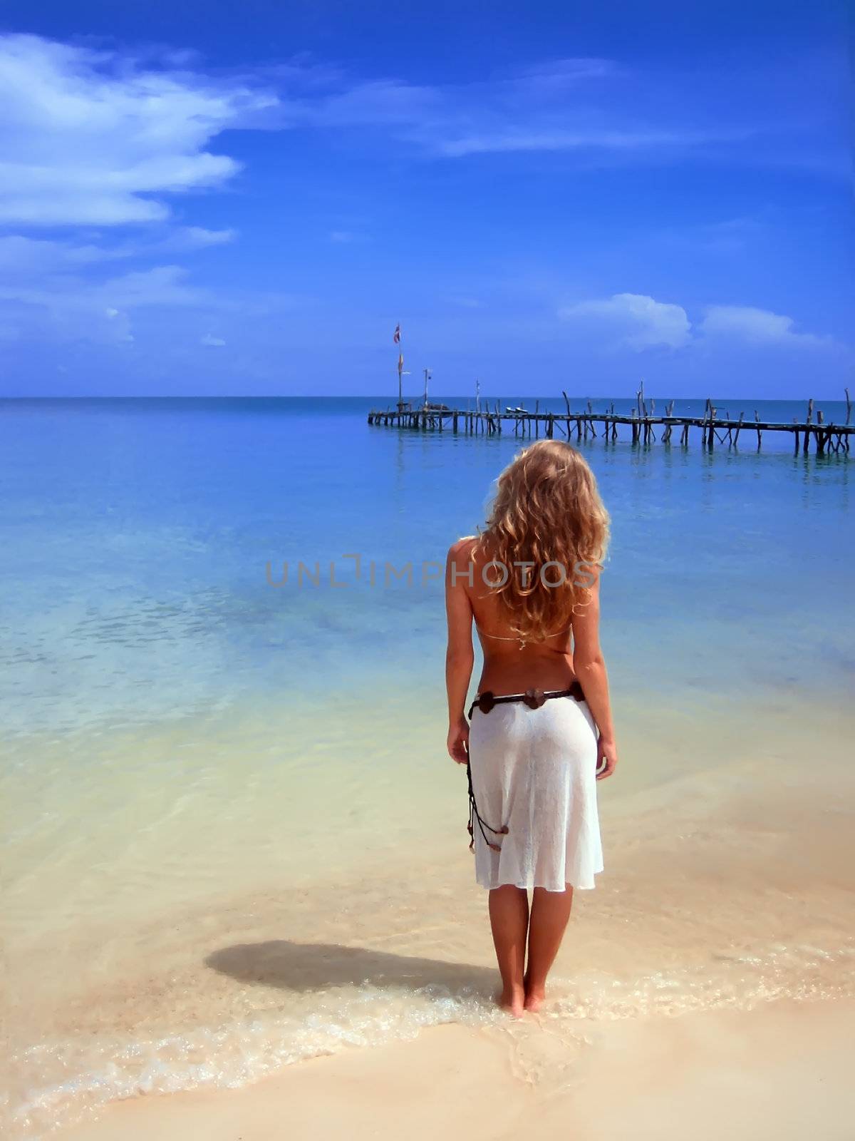 A girl standing and looking at the lonely pierce