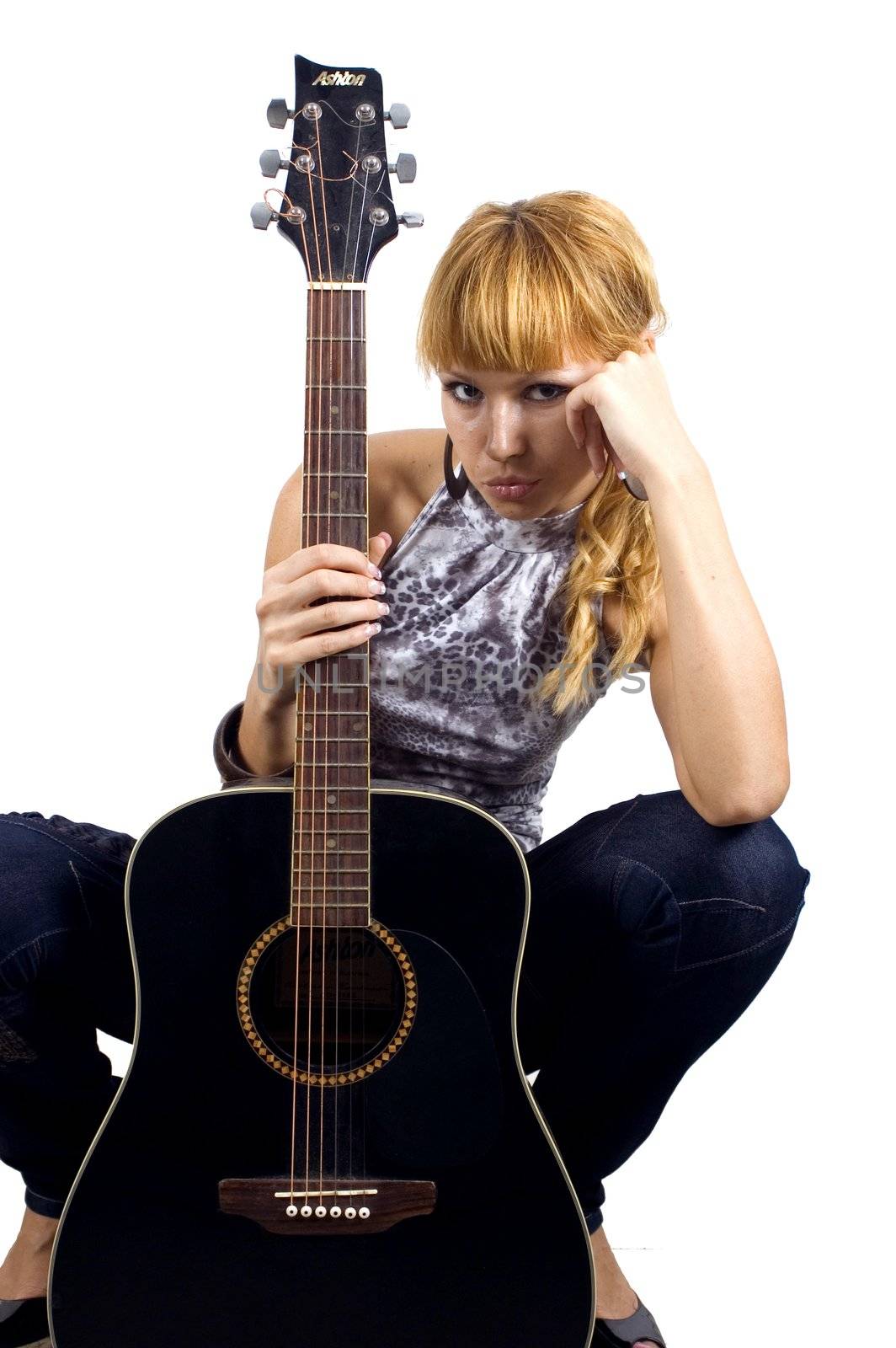 Pretty, blonde girl holding guitar, sad face expression, close portrait.