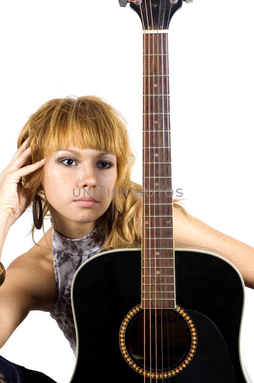 Thoughtful musician. Young, pretty girl - close portrait with black guitar.