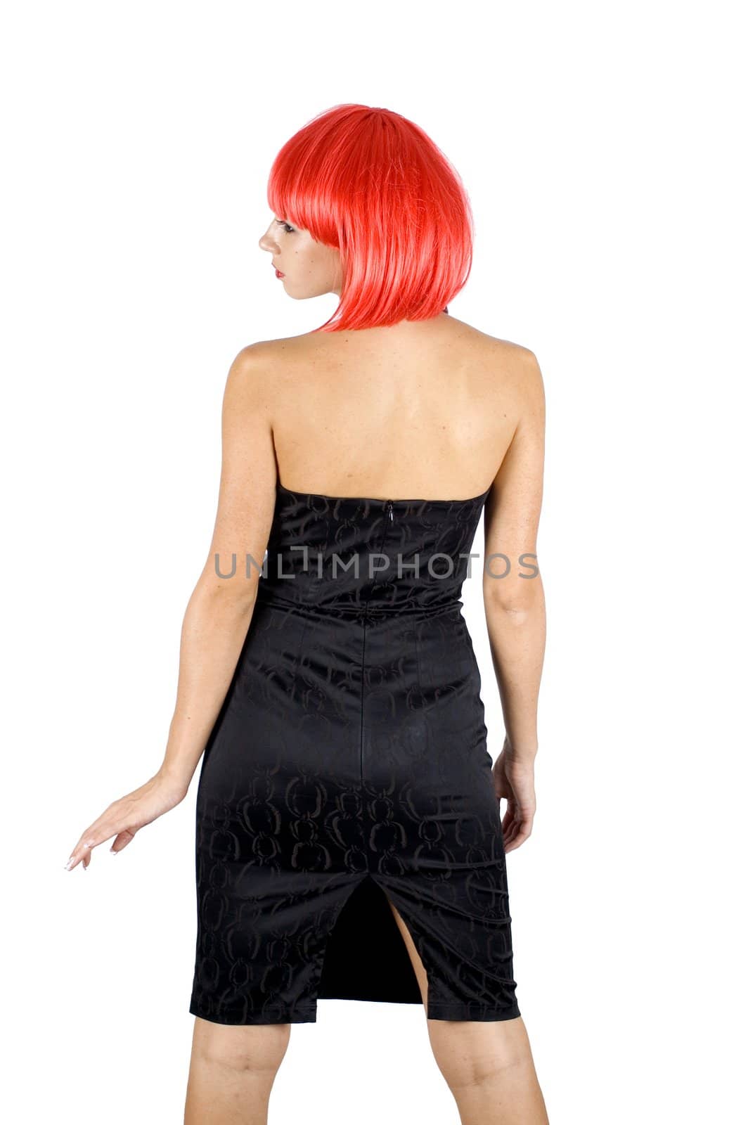 Red hair girl, half turned for photo. Young, pretty female model. Naughty behaviour, wearing black skirt.