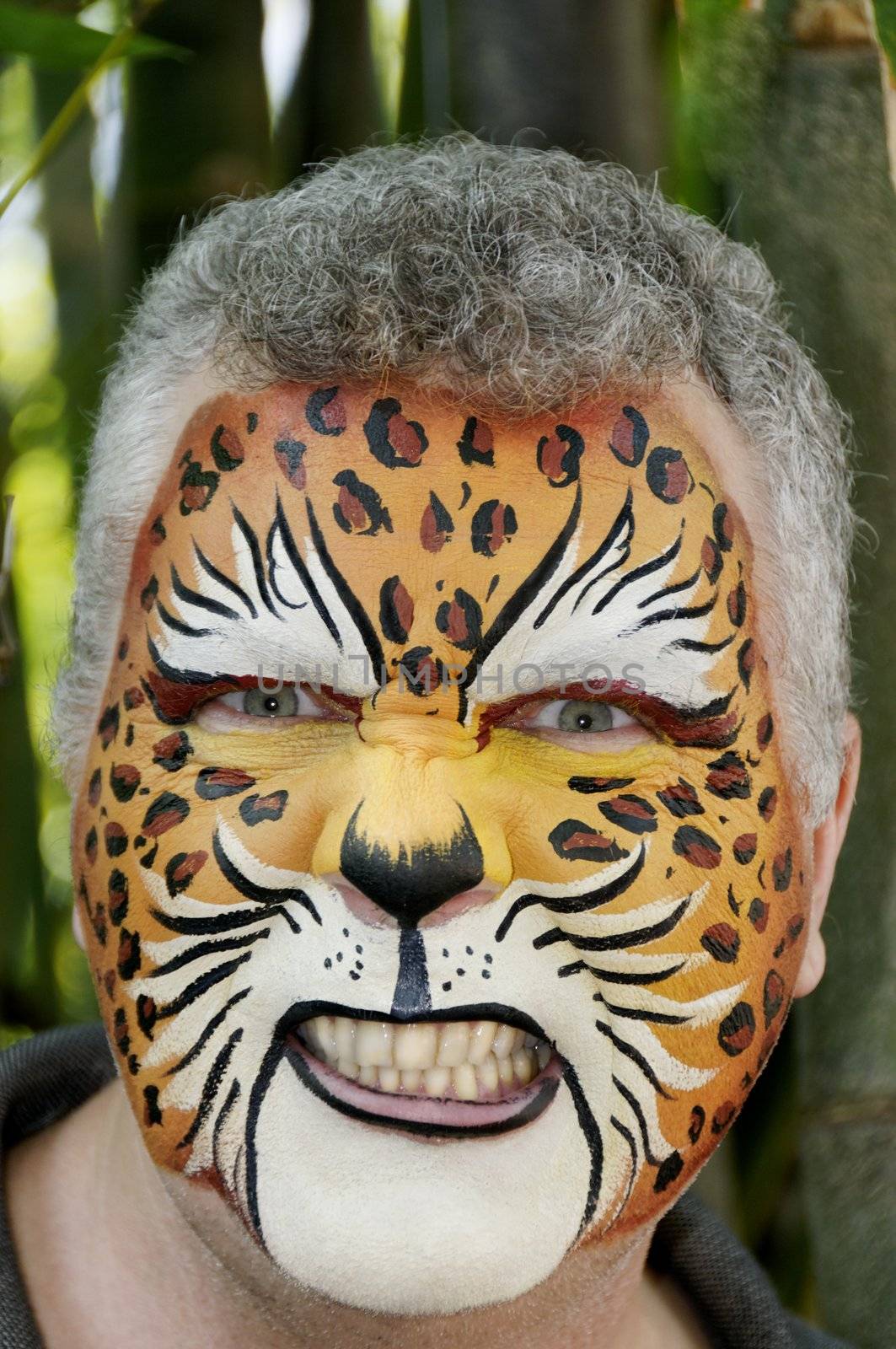 A man growling with a painted face.