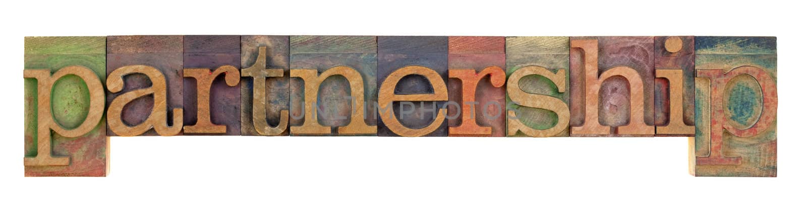the word partnership in vintage letterpress type blocks, stained by color inks, isolated on white