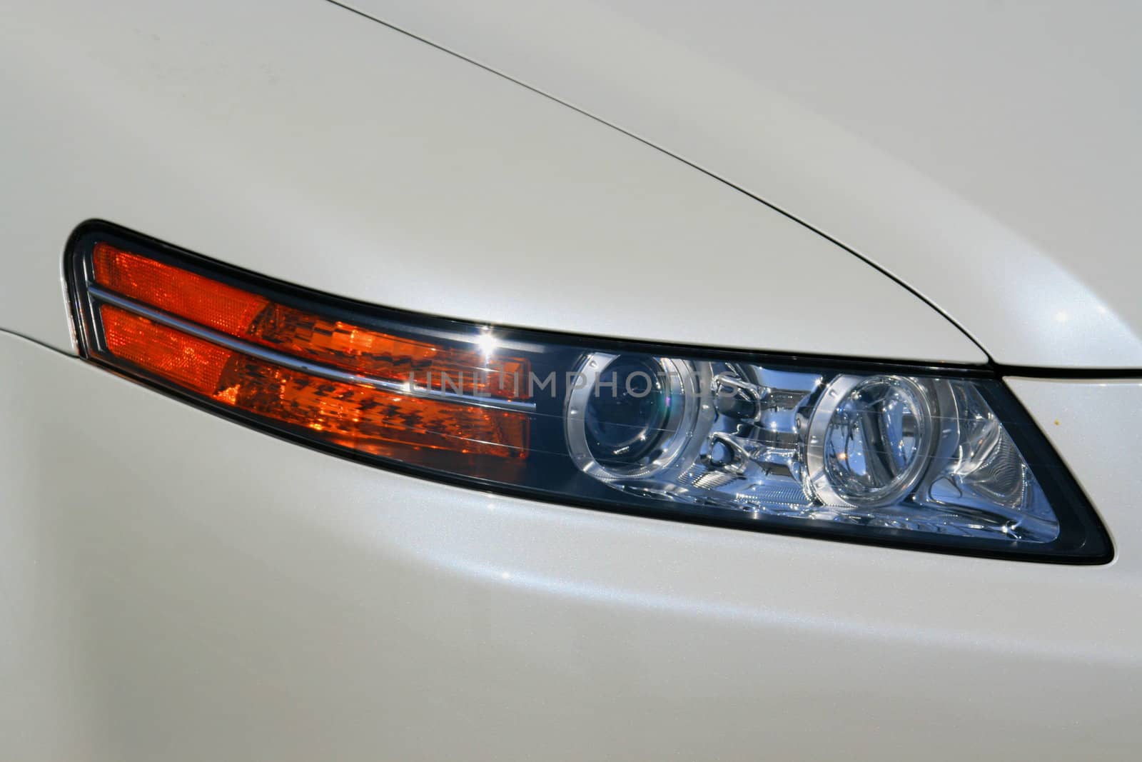 Close up of the headlights of a sports car.
