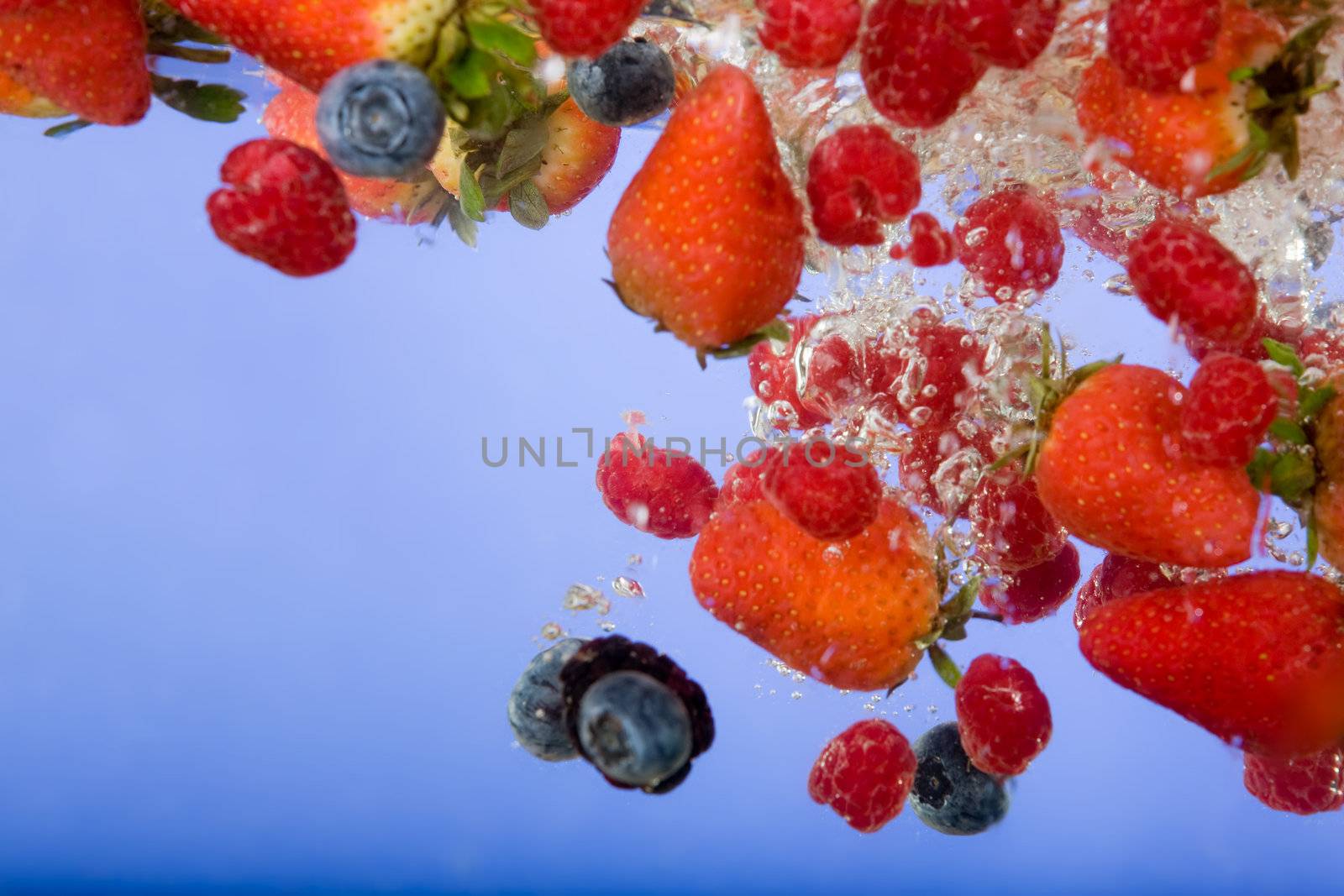 Fruit splashing in water background - shallow depth of field