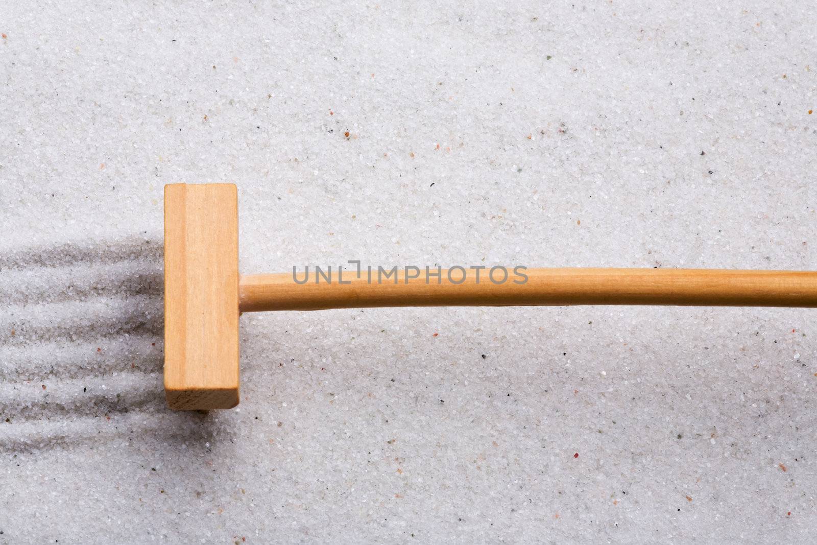 A small rake, creating a design in a zen garden