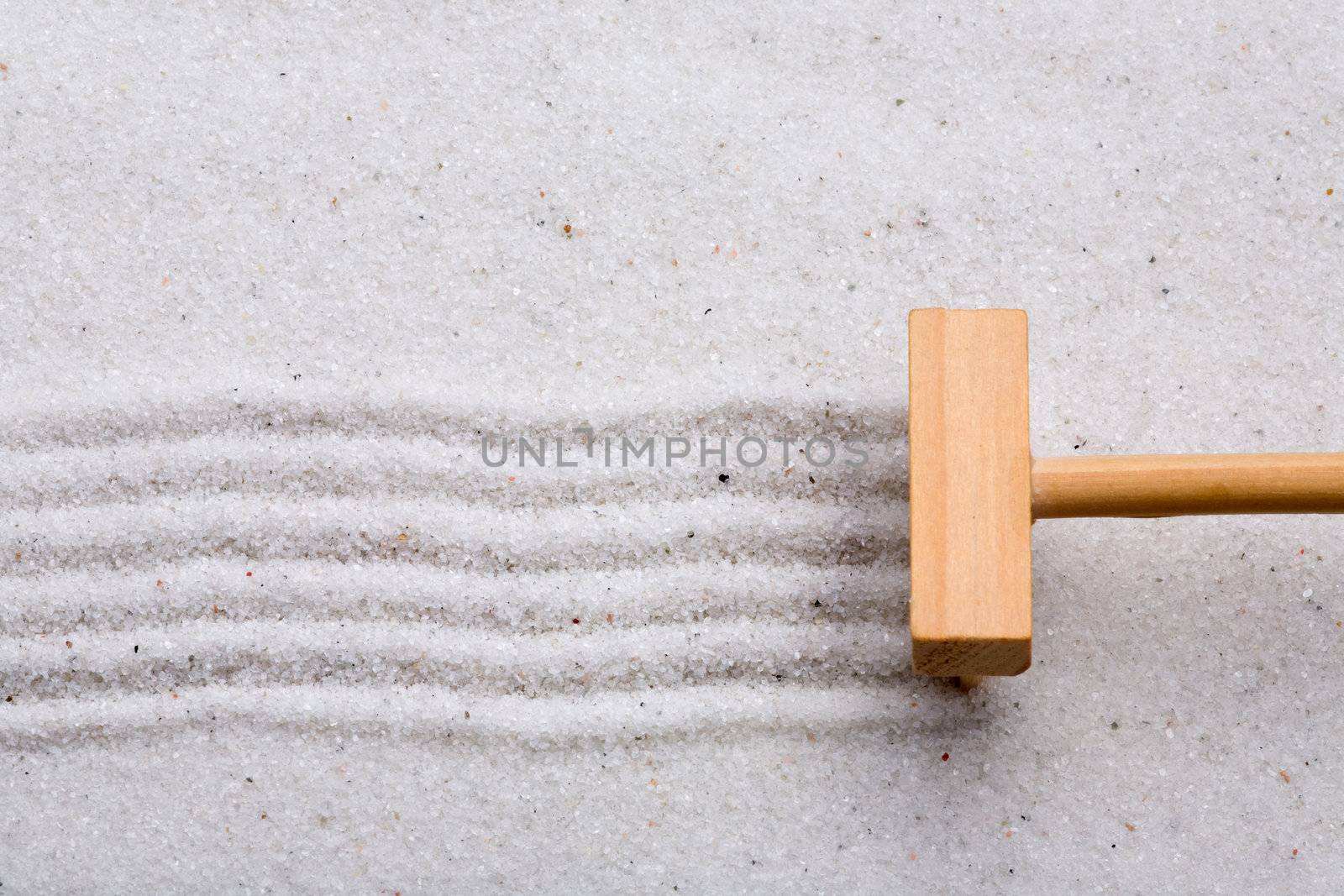 A small rake, creating a design in a zen garden