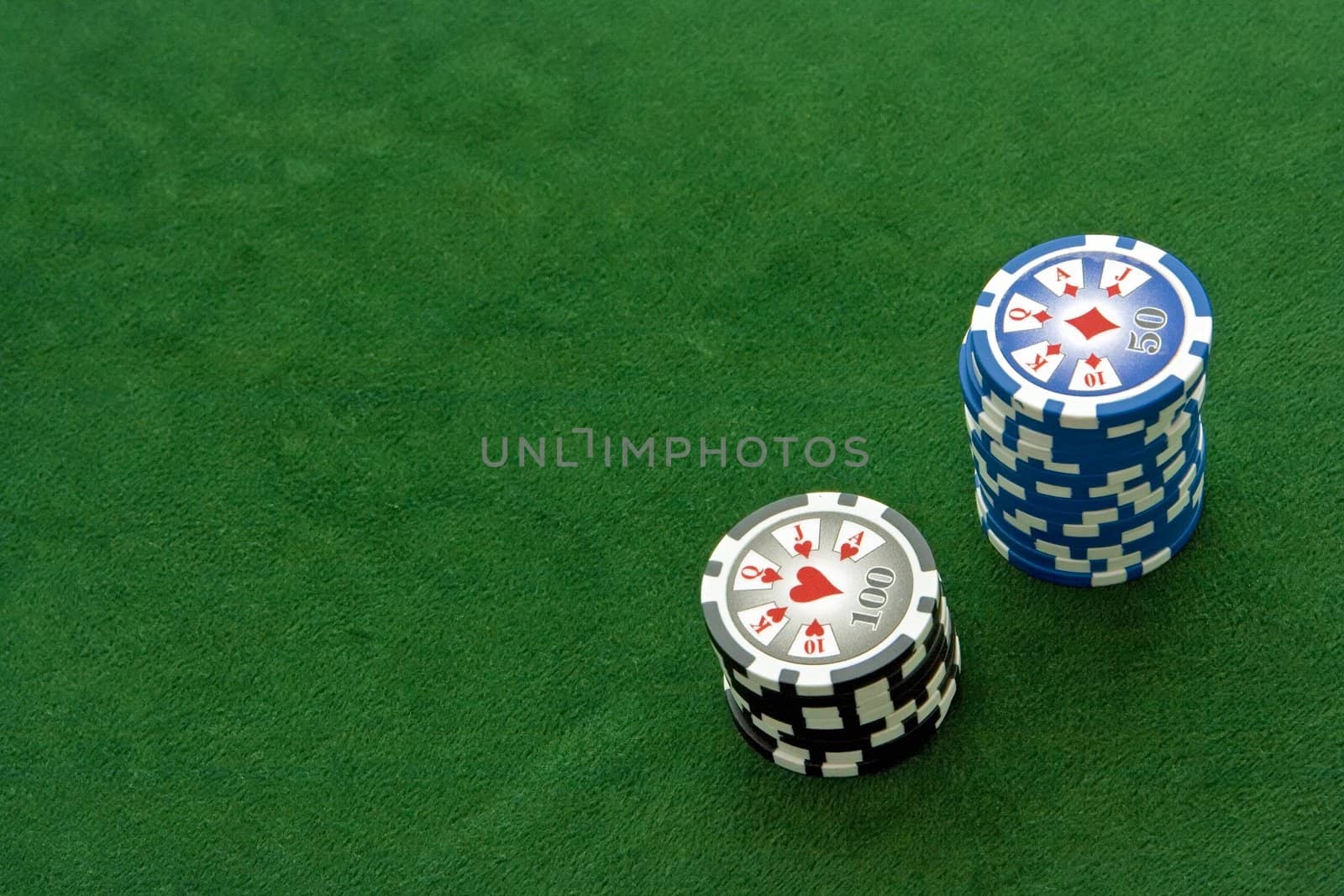 Poker table with 50 and 100 dollar chips on it