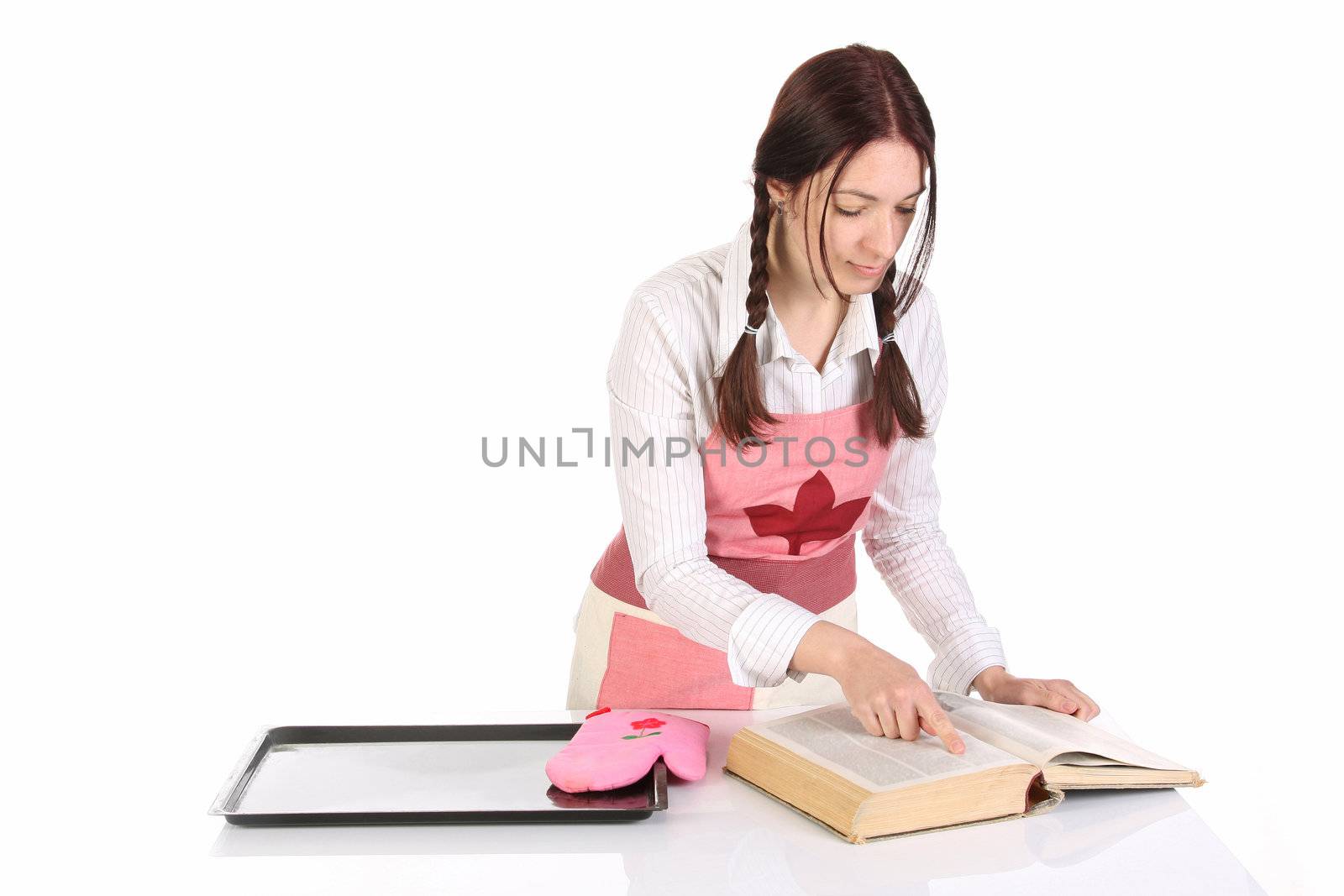 beautiful housewife preparing and reading with a book recipe