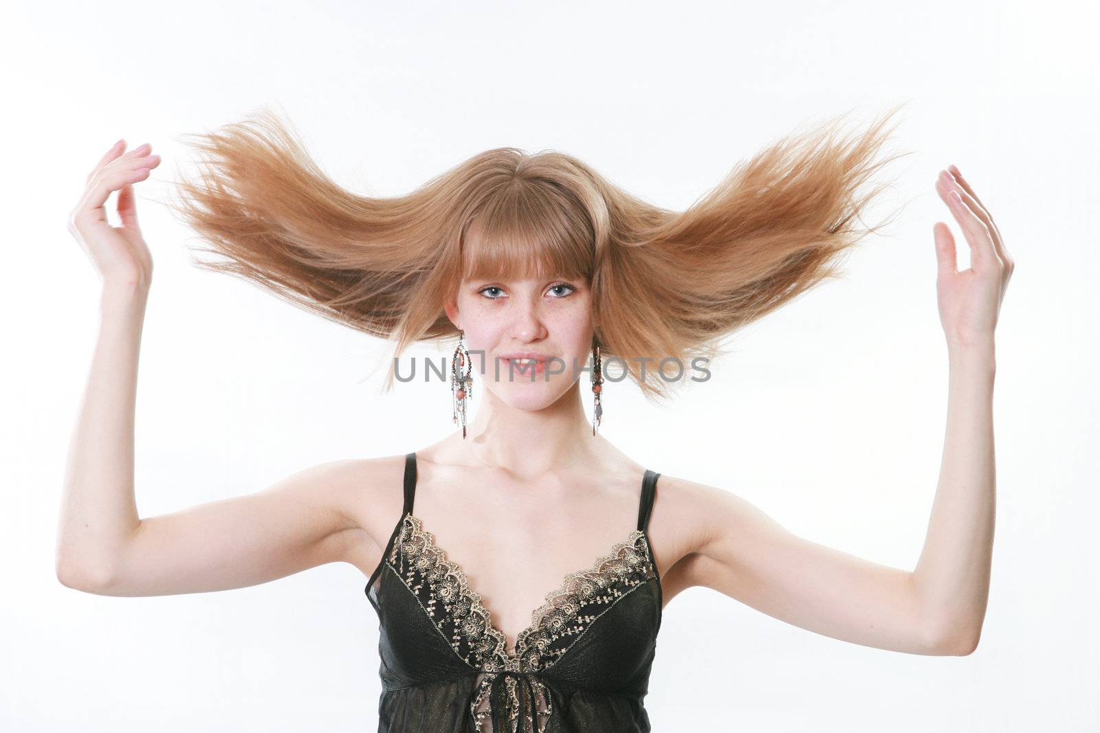 The young woman poses on a white background