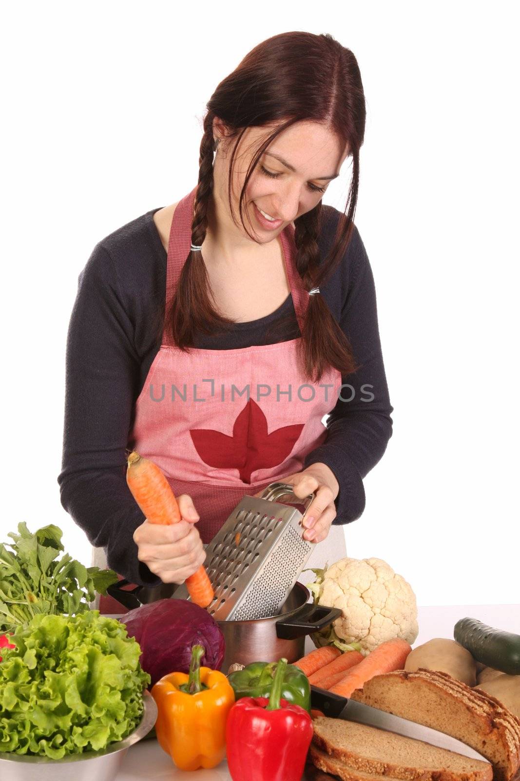 housewife preparing lunch and cutting carrot with stainless grater
