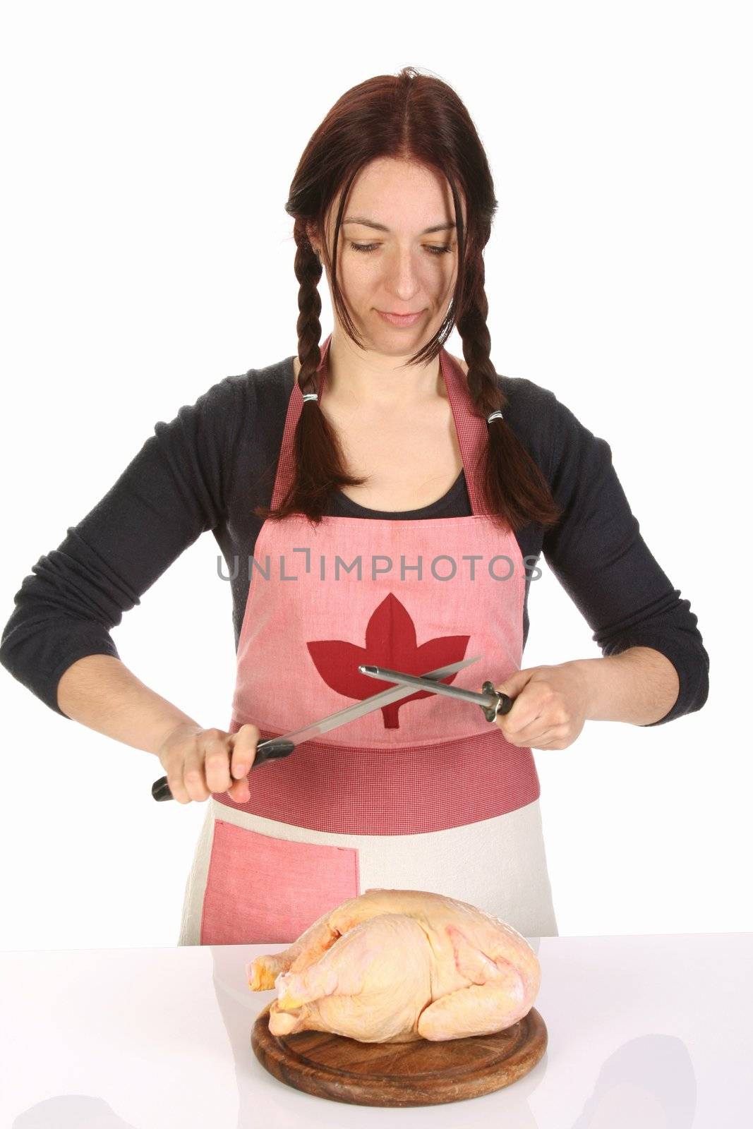 beautiful housewife sharpening a knife with sharpener 