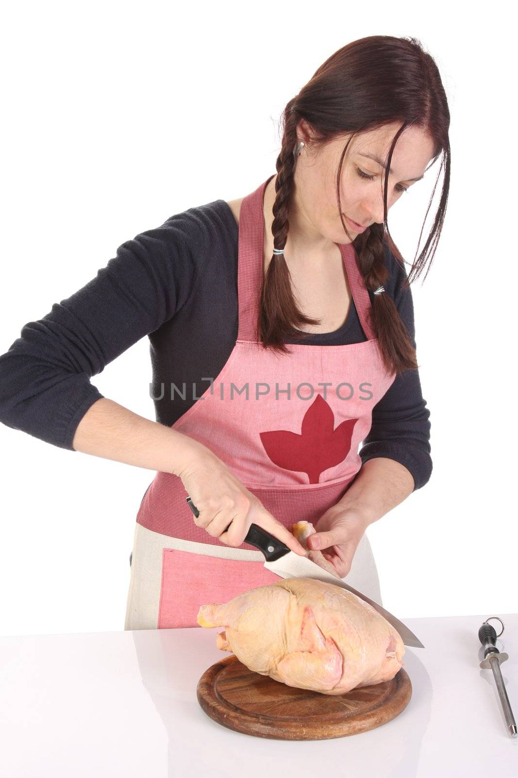 beautiful housewife cutting chicken on white background