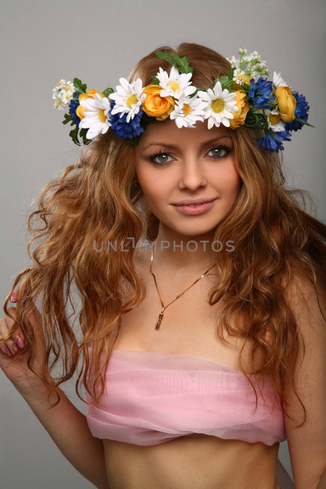 girl with wreath of flowers on her head by skutin