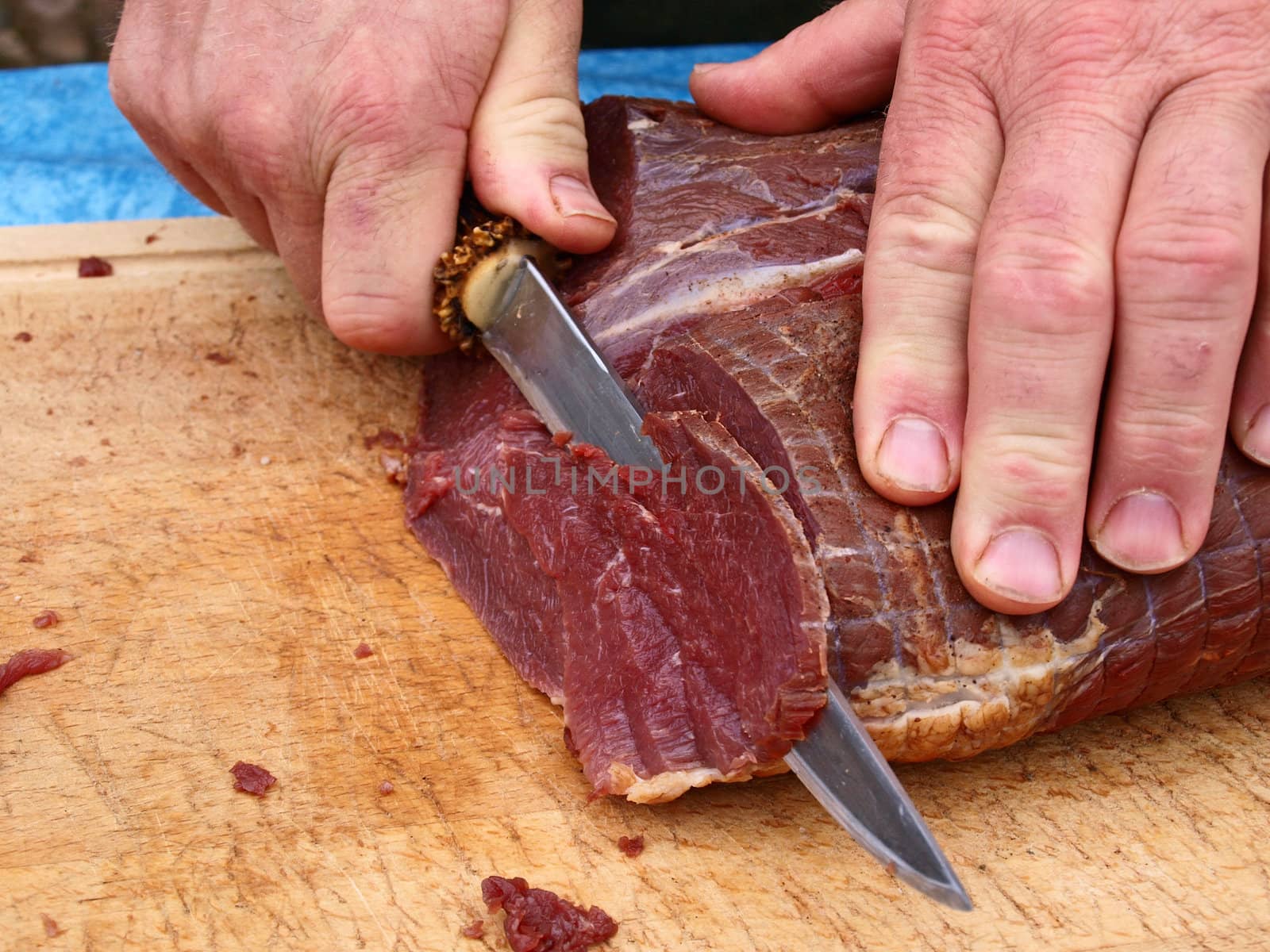 Cut smoked roasted meat beef by a professional chef butcher