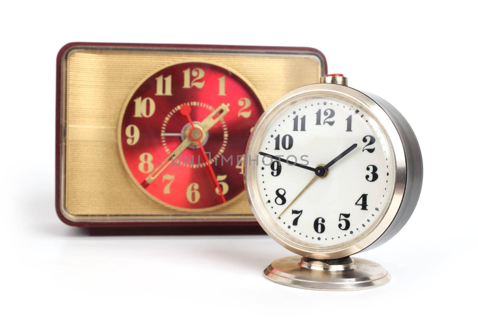 old alarm clock with gold trim on a white background