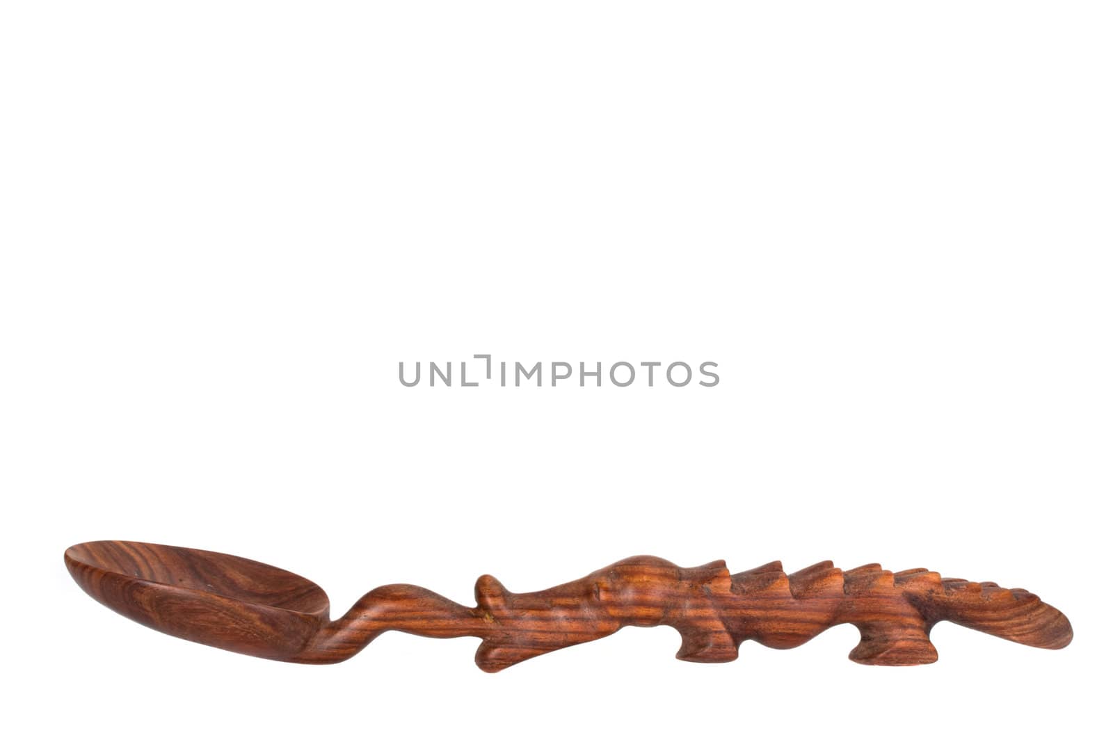 a carved spoon in the shape of a crocodile