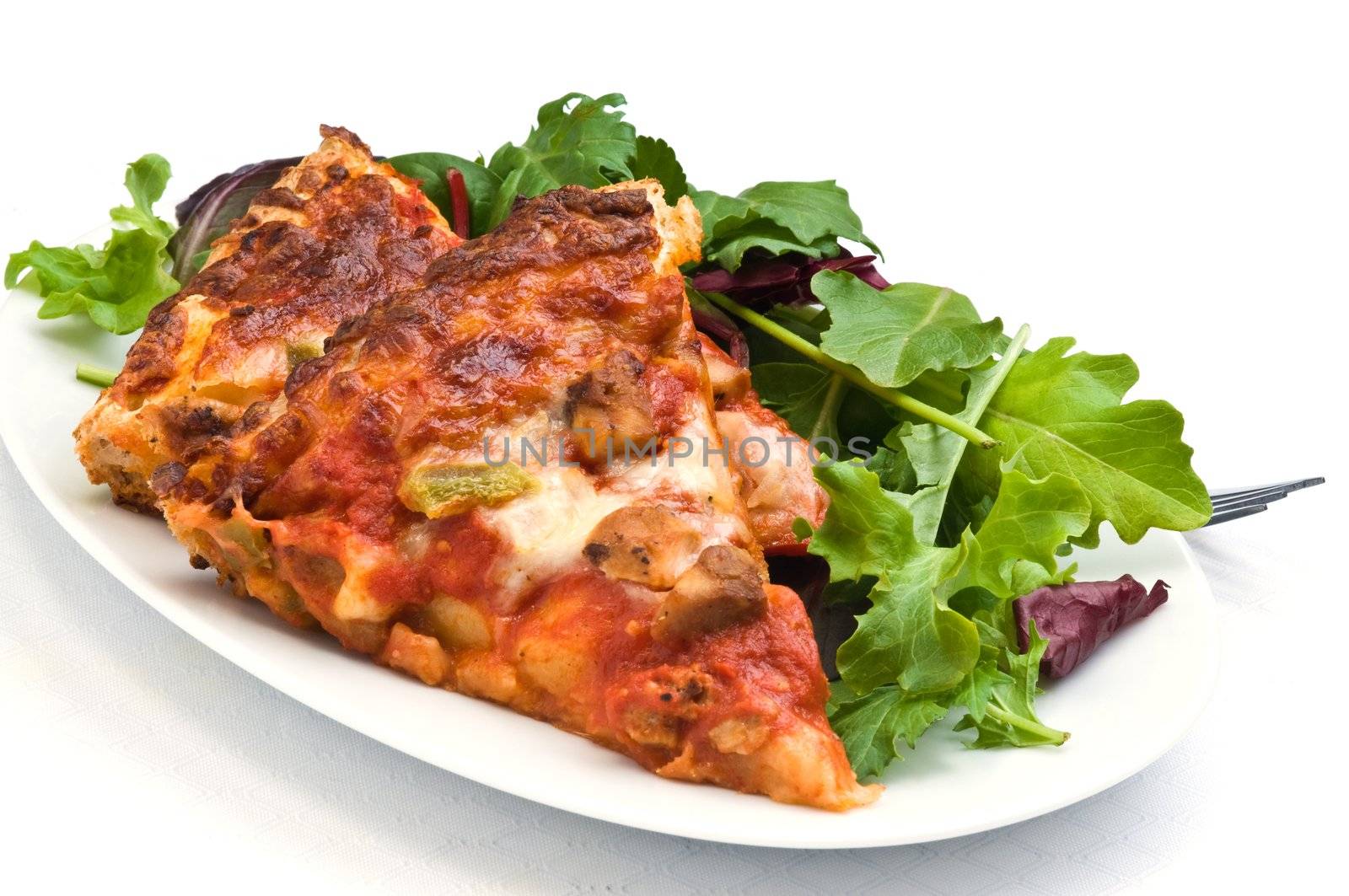 Delicious homemade pizza served with mixed greens.