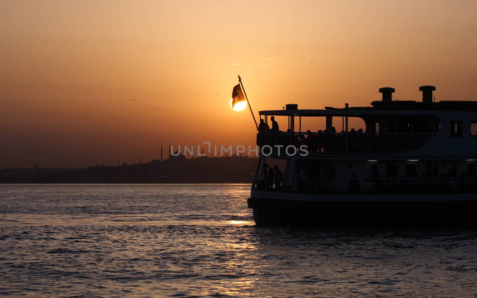 Passenger Ferry sailing across Bosporus during sunset. Istanbul, Turkey