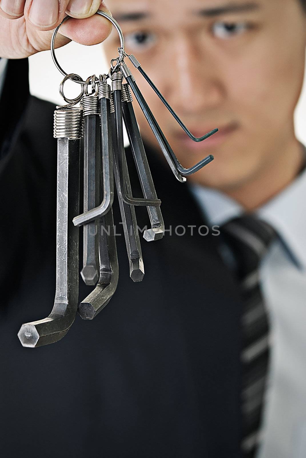 Businessman hang up tools on hand and watch.