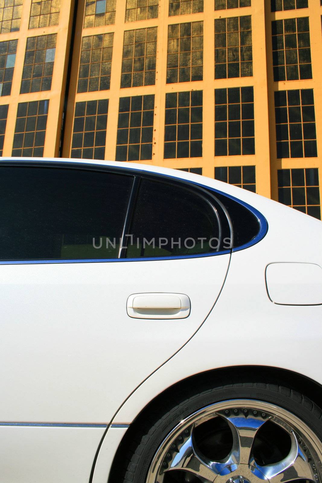 White Lexus GS with chrome rims and tinted windows.
