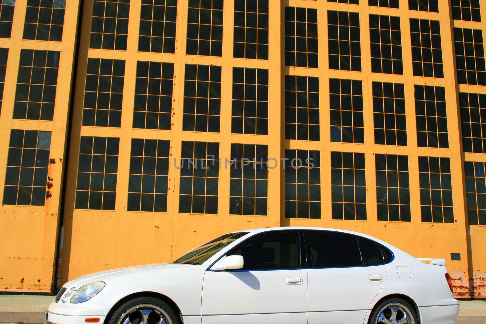 White Lexus GS with chrome rims and tinted windows.
