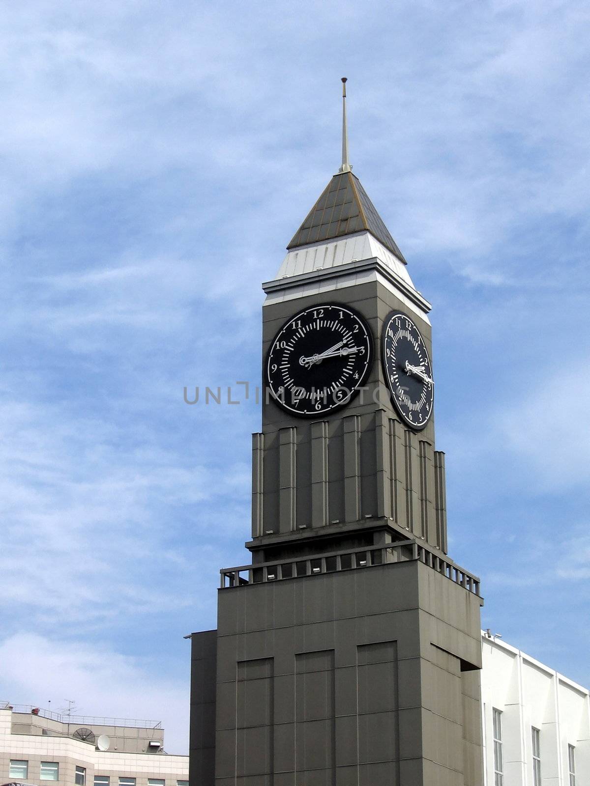 Tower with clocks in Krasnoyarsk city on a background of blue sky