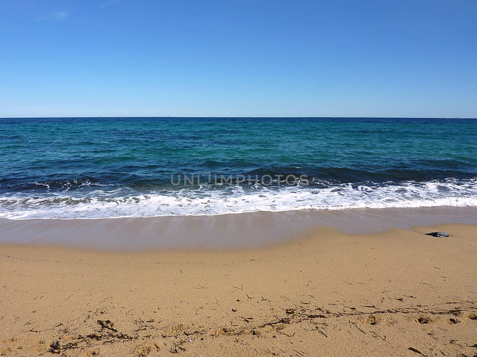 Waves of the blue mediterranean sea on a sand beach, France, by beautiful weather