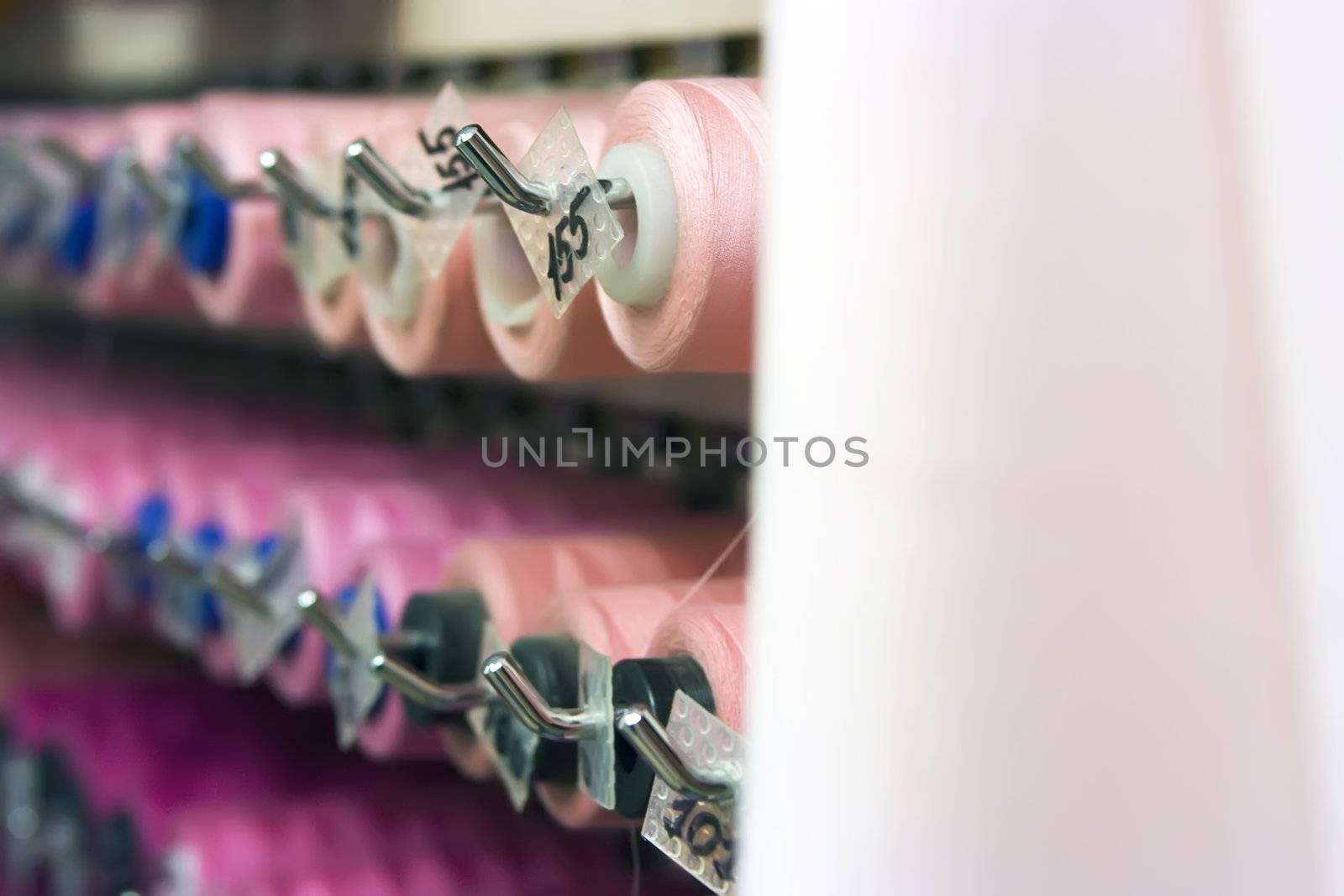 A lot of thread spools attached to a wall