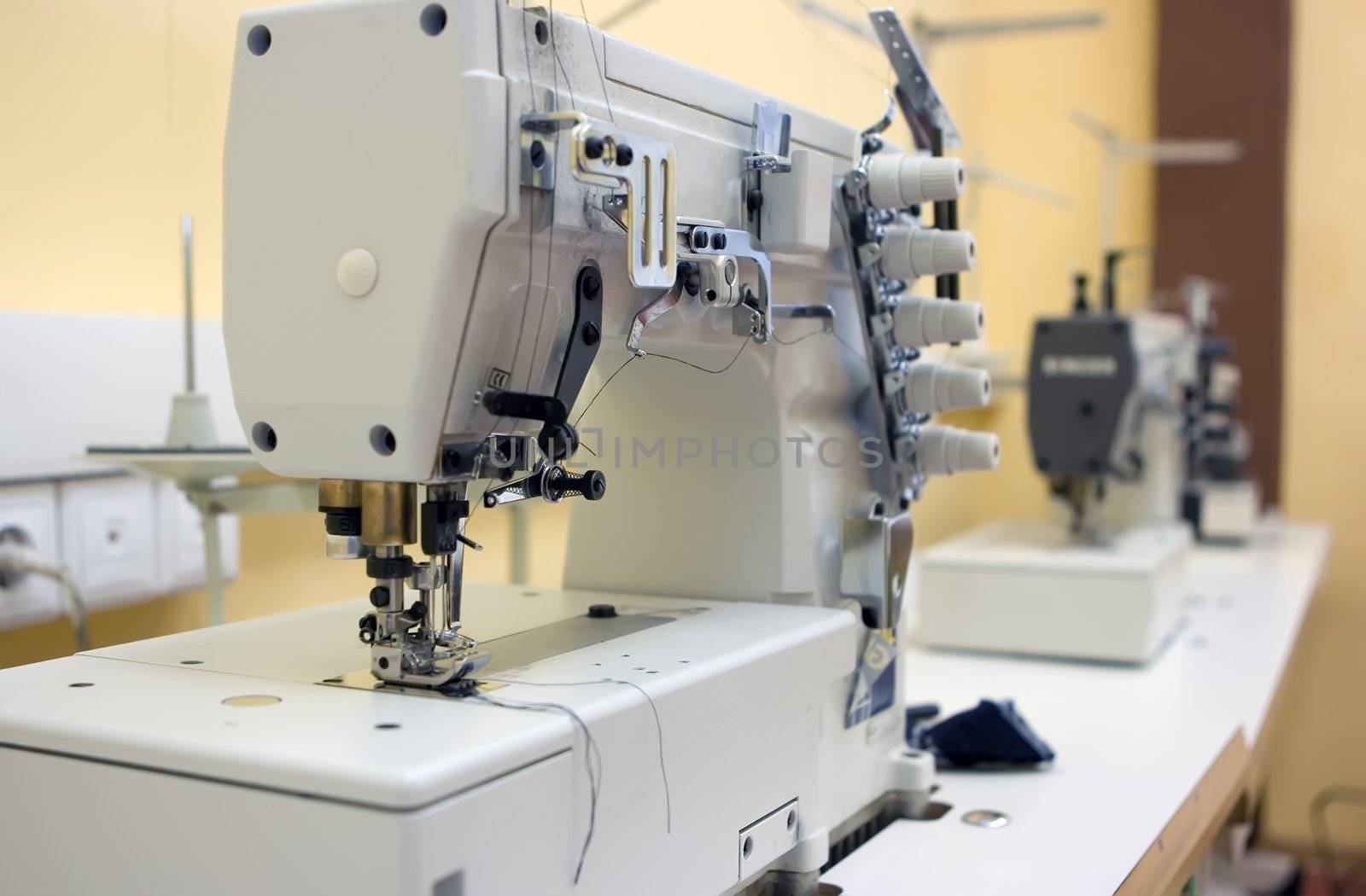 Two sewing machine on a table