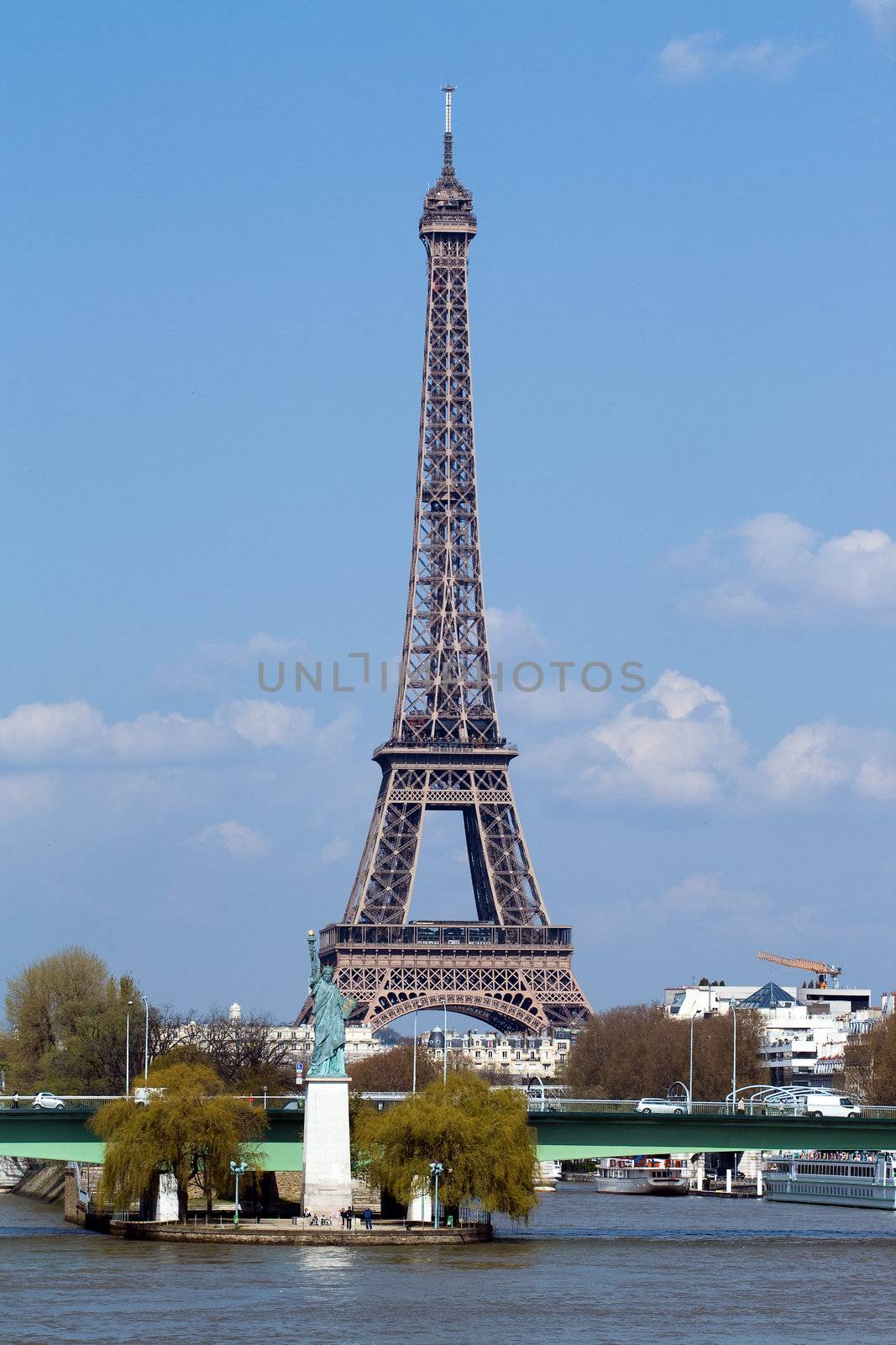 Statue of liberty on the river Seine and Eiffel tower in Paris, France, Europe