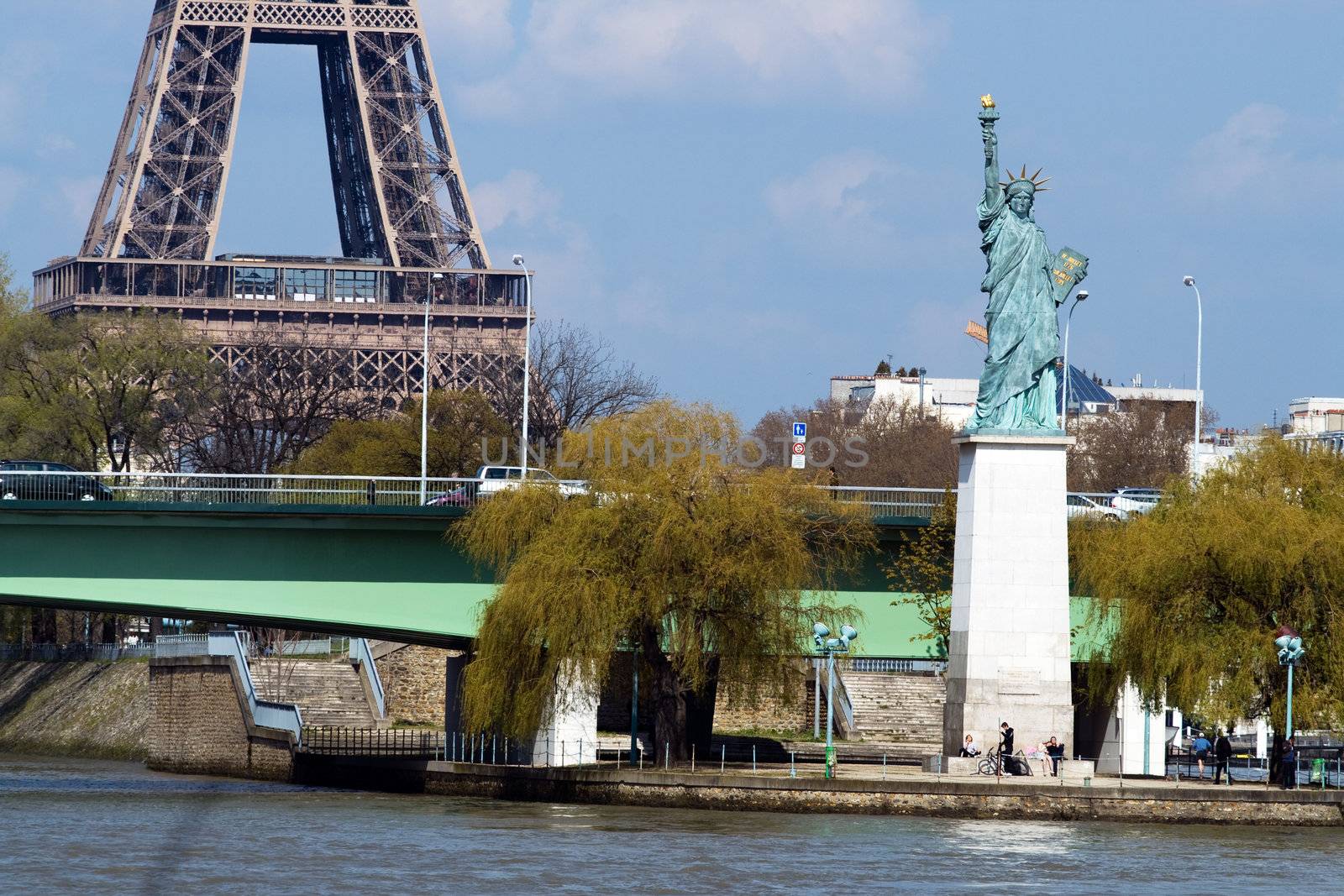 Statue of liberty on the river Seine and Eiffel tower in Paris, France, Europe