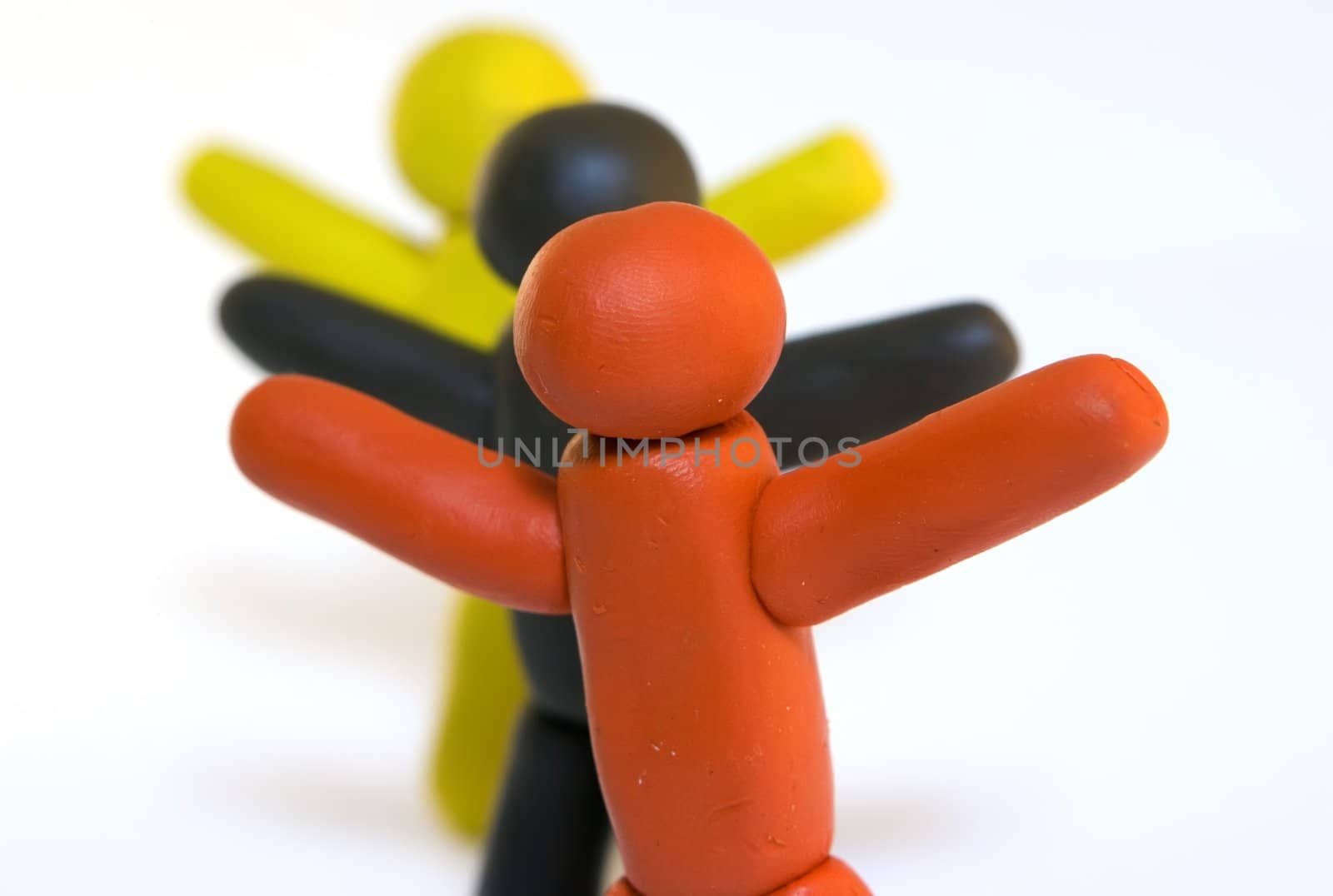 Three plasticine men standing isolated on white background