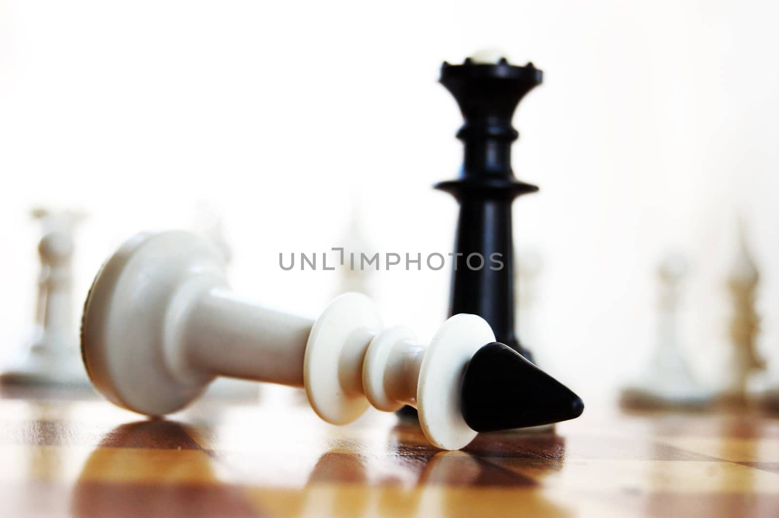 defeat in chess white king lying on board