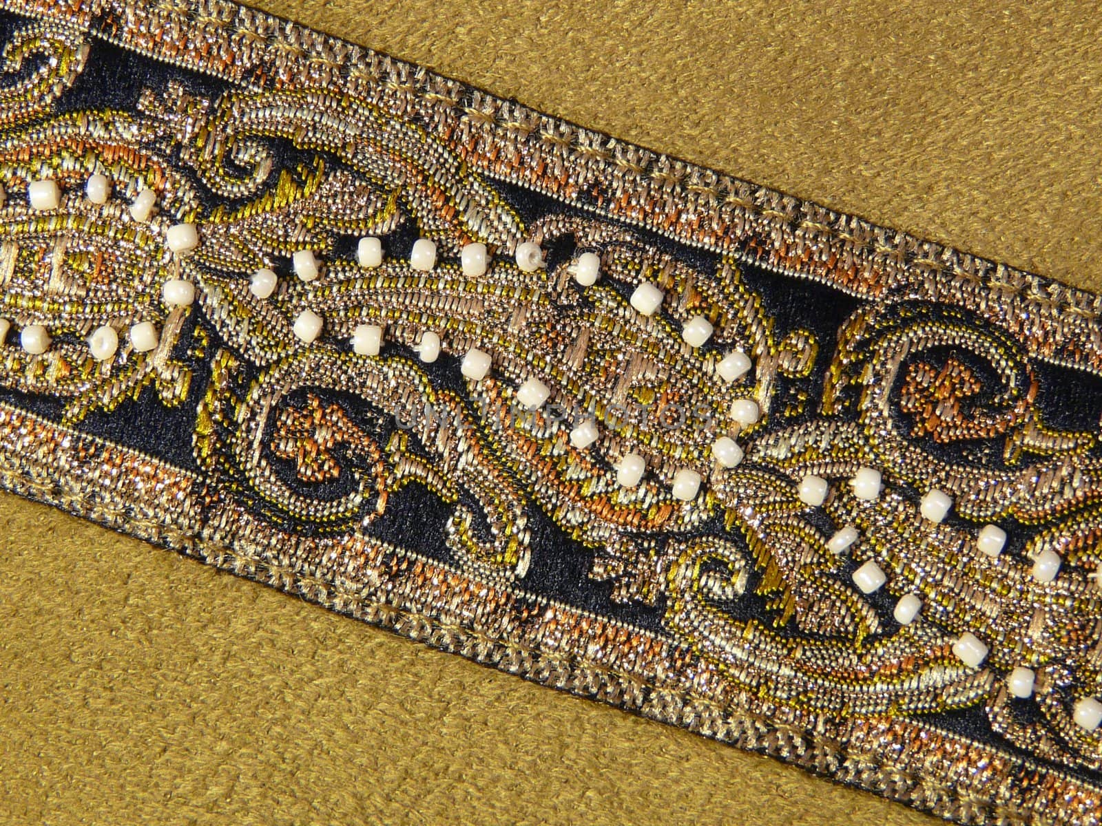 Beautiful oriental pattern on piece of brown cloth